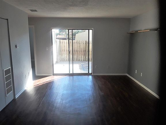 Living room w sliders to fenced-in patio/yard