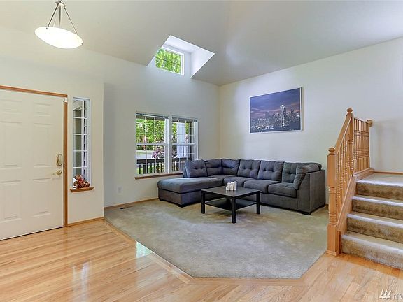 Enter to gleaming hardwood floors and vaulted ceilings.