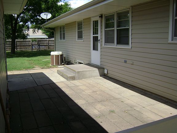 There is a patio between the house and the garage