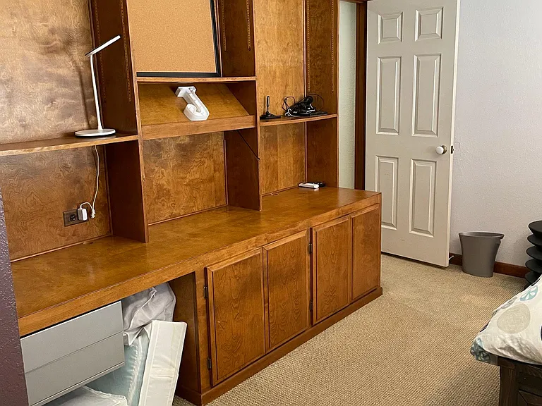 Builtin cabinetry make this bedroom ideal for an in home office.