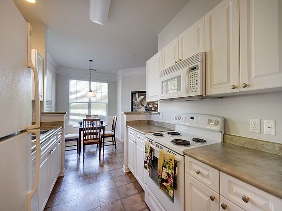 Kitchen with white appliance package and tile floors