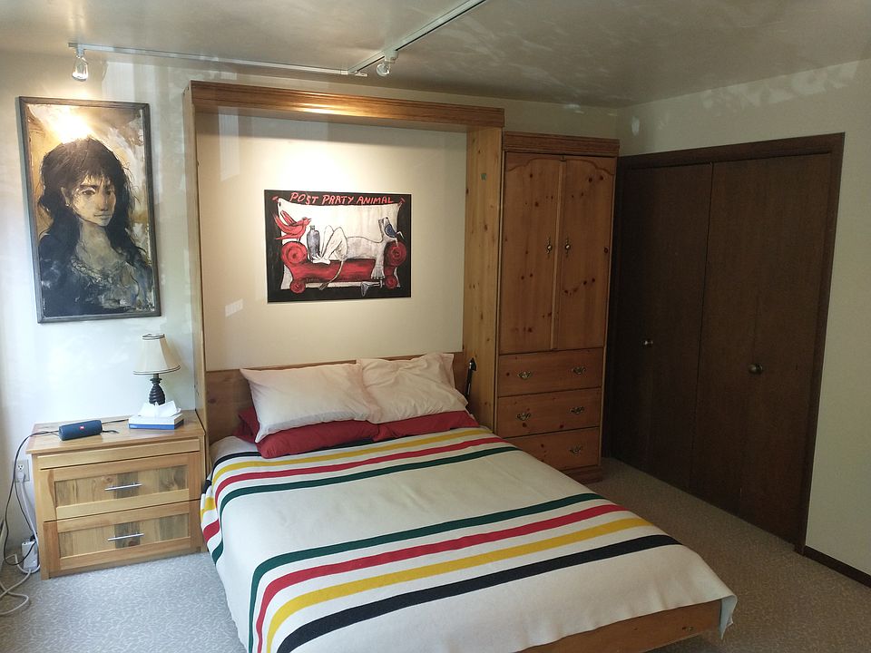Queen size murphy bed, Pendleton wool blanket, original art.