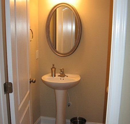 1/2 Bath downstairs (before upgraded ceramic tile and paint)