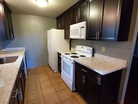 Modern kitchen with granite countertops. Appliances in good working condition