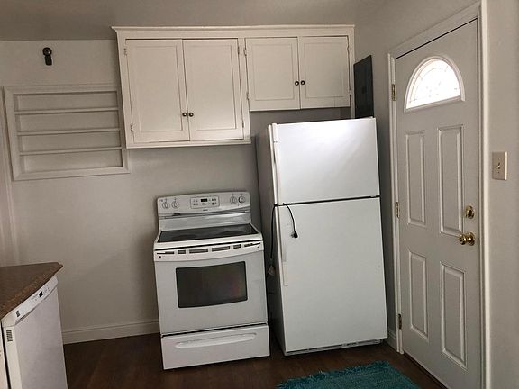 Back door, more cupboards, stove and fridge