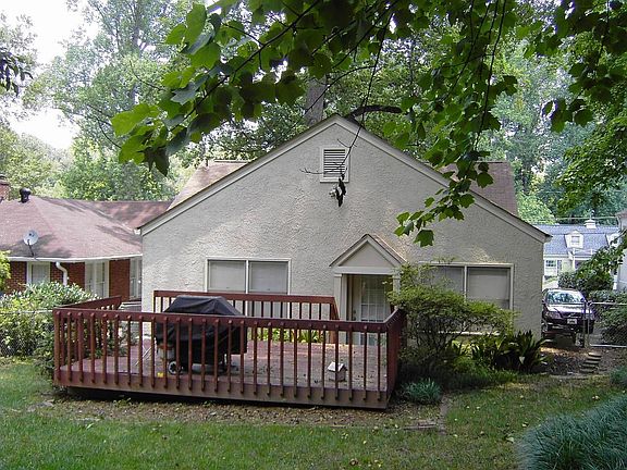 Large Deck overlooks manicured yard. 