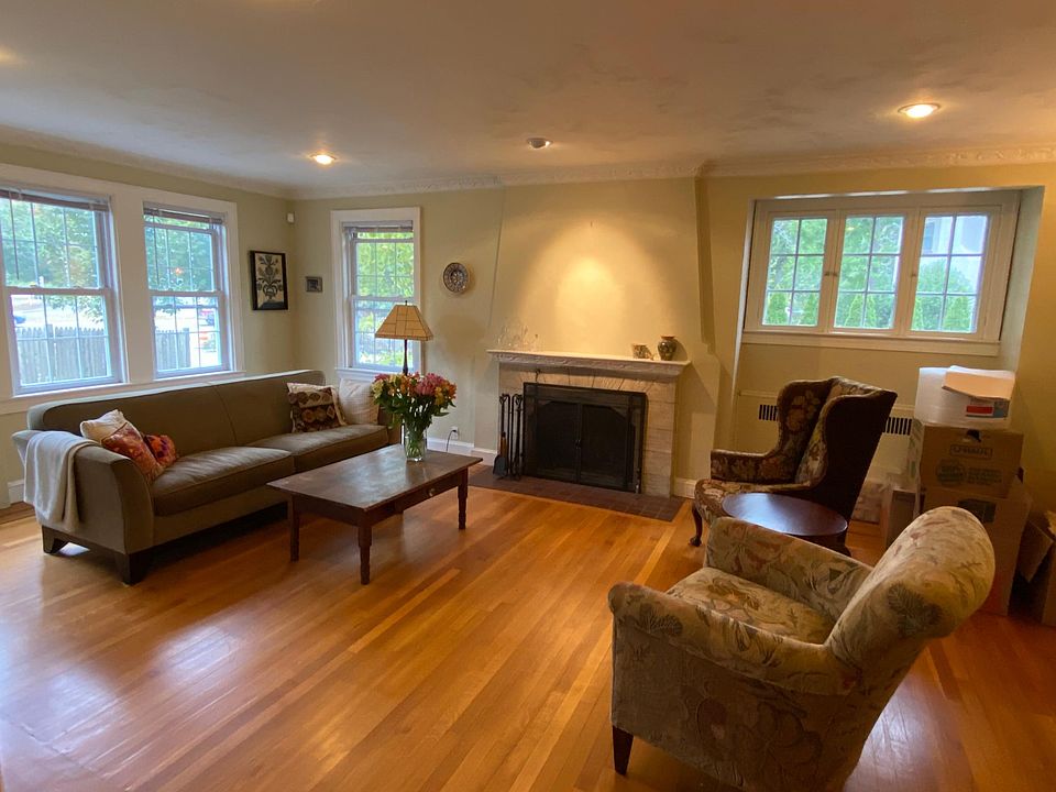 Spacious living room with wood burning fireplace and recessed lighting