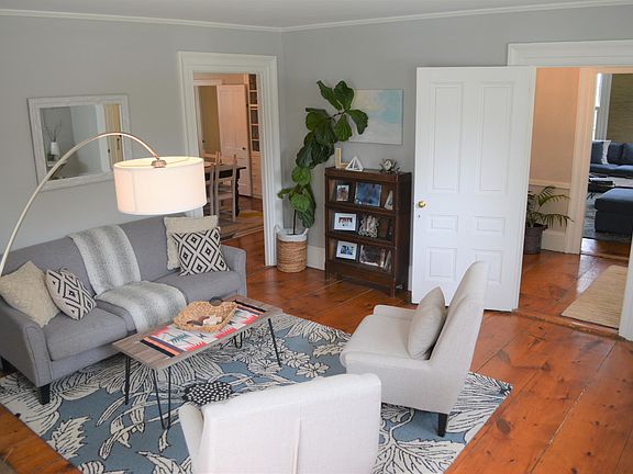sitting room with fireplace to the left of the entryway