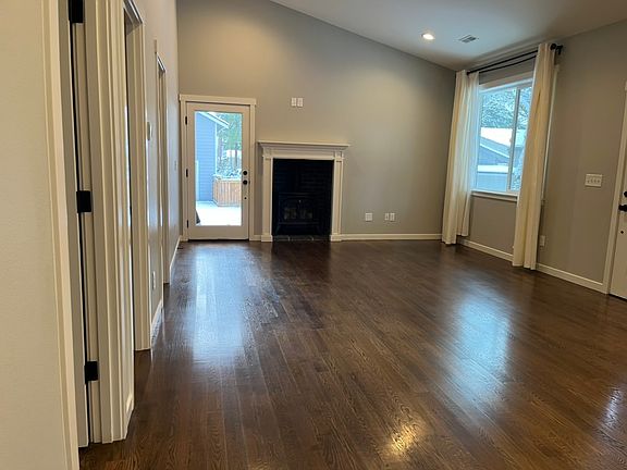 View of living area and back door from kitchen.