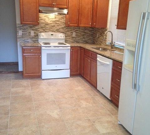 Kitchen with granite and glass tile backsplash