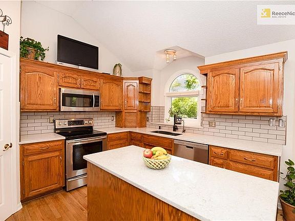 Newly Remodeled Kitchen with Quartz Countertops, Subway Tiles, Stainless Steel Appliances, Walk-In Pantry, Vaulted Ceiling and Center Island.