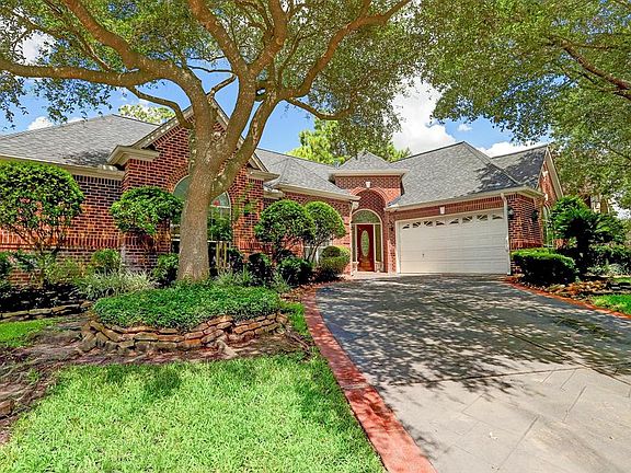 Pretty shade trees in front with many beds. Sprinkler system to conserve water and keep everything looking green and fresh.