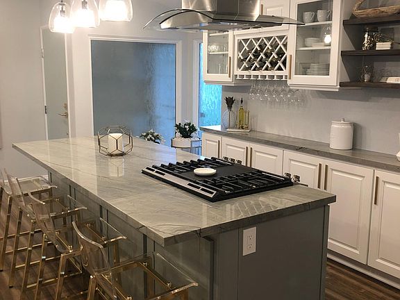 Kitchen. Wine holder (10 bottles), wine glasses as well. Large glassware cabinets, big windows by the front door for tons of natural light.