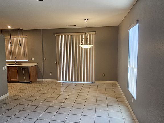 Kitchen on left of sliding glass door to back fenced yard.