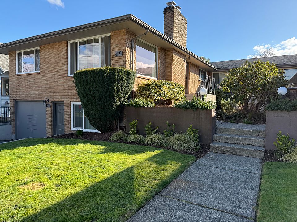 Unit 101 is the top left unit. Photo shows the walkway to 101 front door, and a glimpse of private driveway and single car garage.