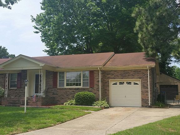 Wide driveway with large detached garage