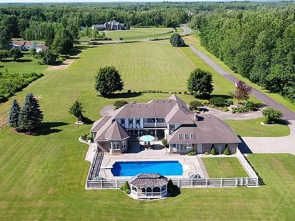 So Incredible, it looks like a Hotel!!! Enjoy the Aerial View of the back of 6000 Sneller Road with its In Ground Pool, Gazebo and Upper Balcony.