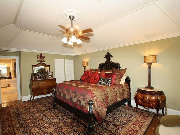 Master bedroom on the first floor w/wood floors & access to outside.