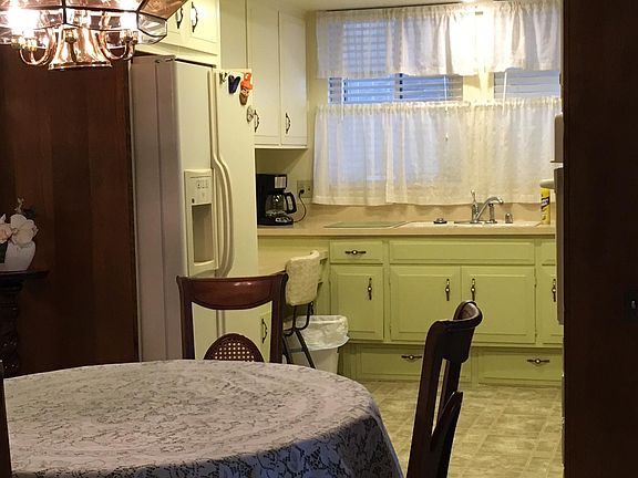 Senior -age 55+ only- short term. Dining room (table has additional leaves) looking towards kitchen. Kitchen has glass cook-top, built in oven, side by side fridge with water and ice through the door, Dishwasher, microwave, coffee maker, toaster, etc.