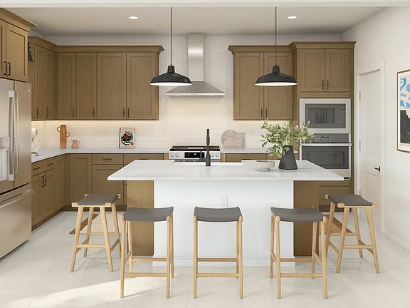 Kitchen with stainless steel hood and pendant lighting