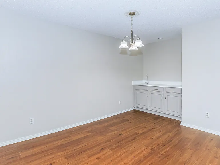 This beautiful huge den includes a wet bar with a hanging chandelier