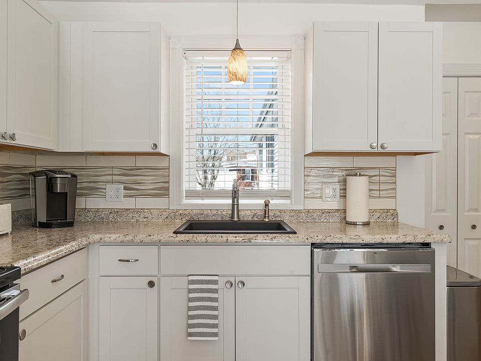 Kitchen, Stainless Steel Appliances, Dishwasher, Granite Countertops, White Cabinetry, Subway Tile Backsplash, Pendant Light, Under-mount Sink.