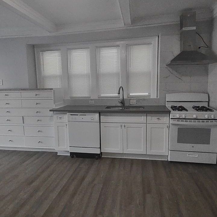 Kitchen with gas stove, dishwasher, and fridge