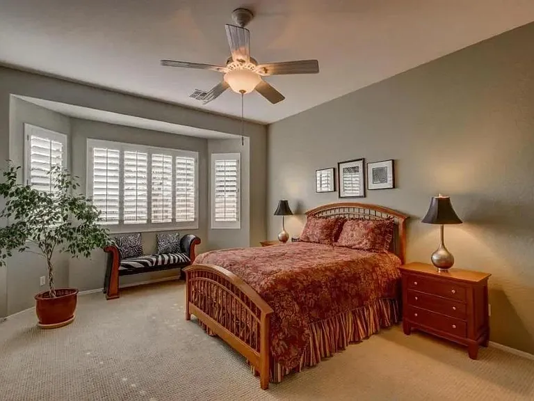 Large master bedroom retreat with lots of natural light and plantation shutters.