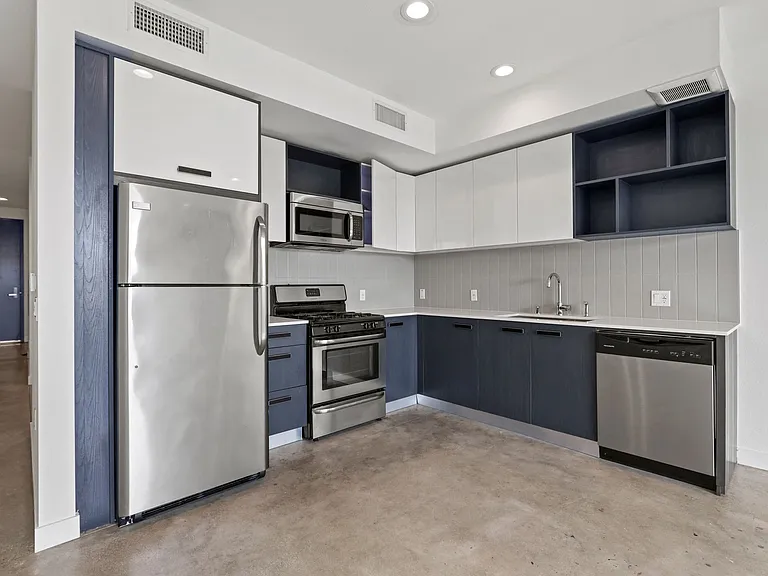 Kitchen with Stainless Refrigerator, Stove, and Microwave Oven