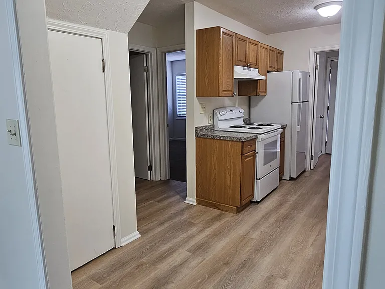 View from living room to kitchen . 1st bedroom on main floor and bathroom to left