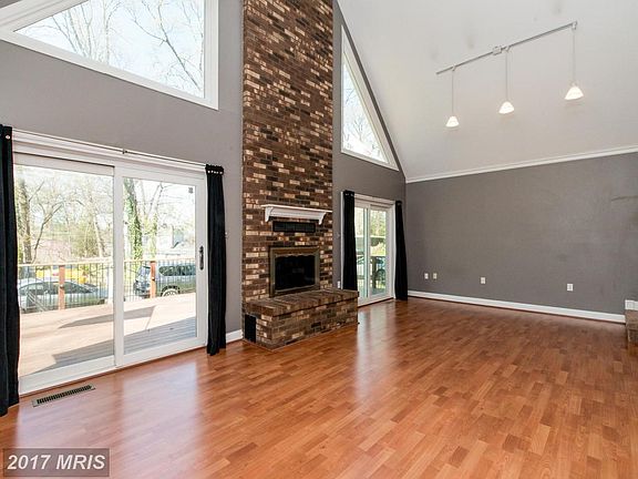 Soaring Brick Fireplace and Sliders to Deck