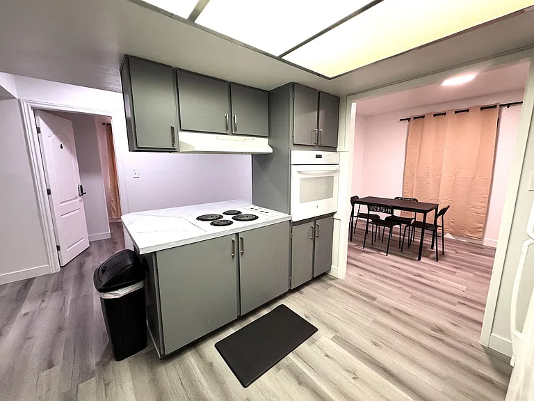 Efficient kitchen with ample cabinetry, cooktop and wall oven, opening to a dedicated dining area for easy everyday meals.