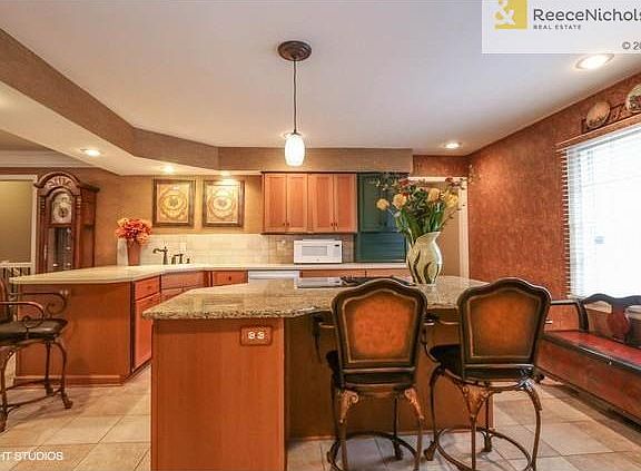 Welcoming kitchen with granite island.