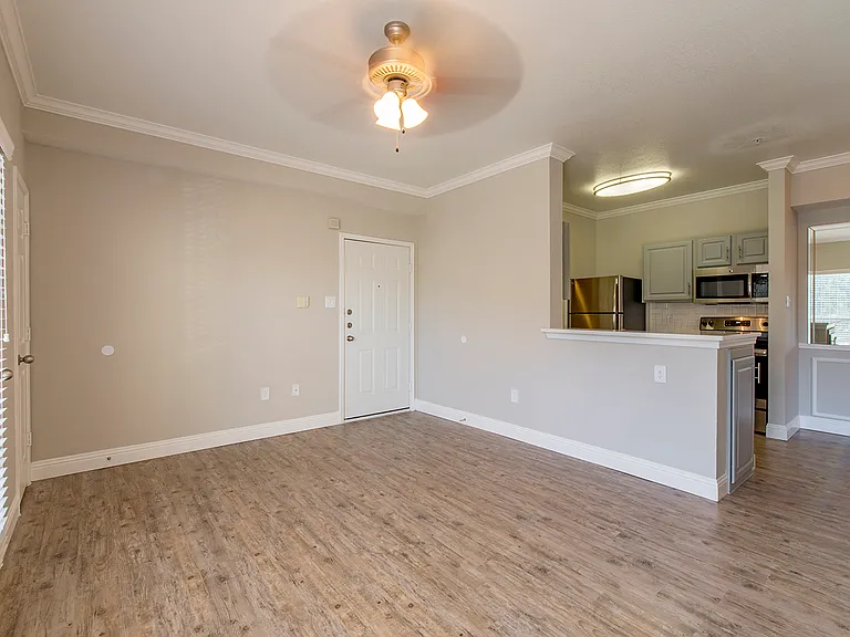Open living room with ceiling fan and neutral finishes