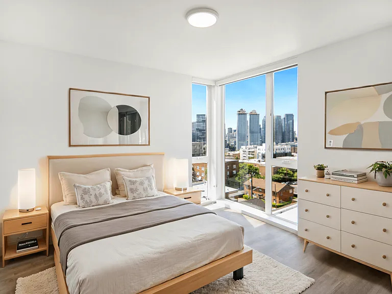 Bright bedroom with a bed and large windows at Alt Capitol Hill.