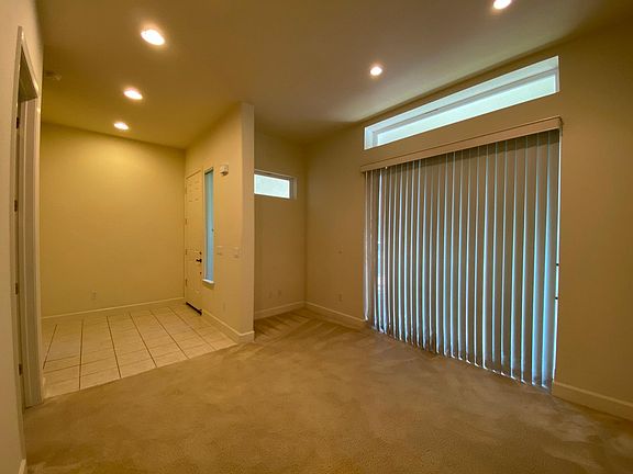 Family Room - open floor with entrance to 1st floor bedroom (on left). Sliding Glass Door to outside front porch patio