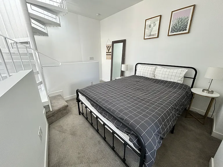 Furnished bedroom with queen bed