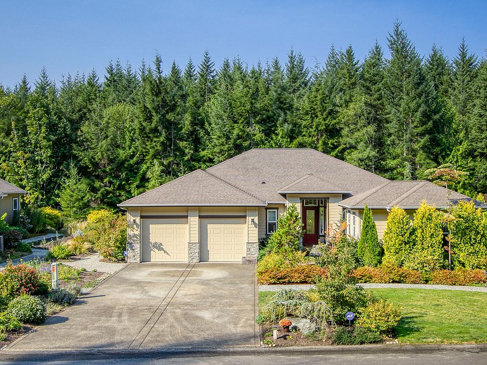 Front view of this beautiful home nestled amongst the trees.