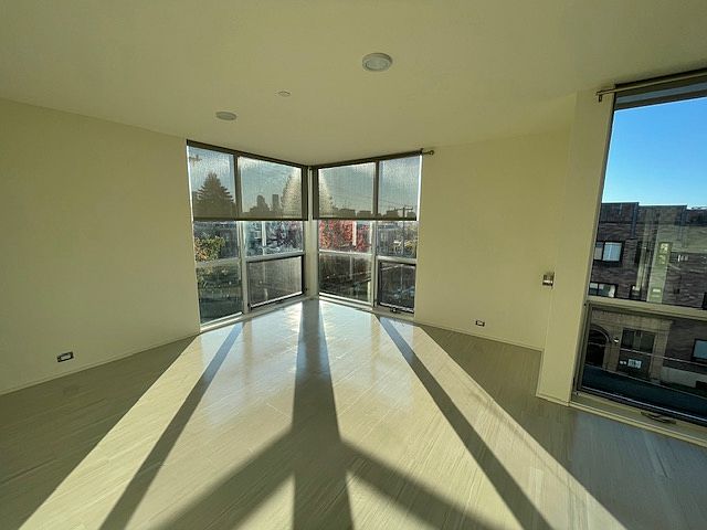 Living room with high ceiling and floor to ceiling windows