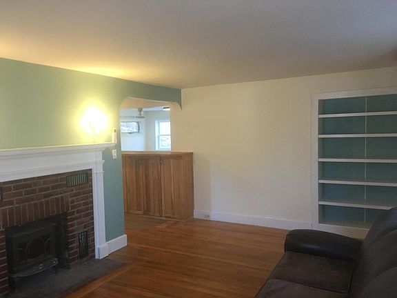 Living Room with wood stove and built in bookcase.