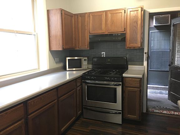 Gas stove, large counter space, lots of cabinets. Small shared back porch.