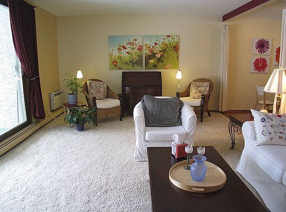 Living room easily accommodates two seating areas.
