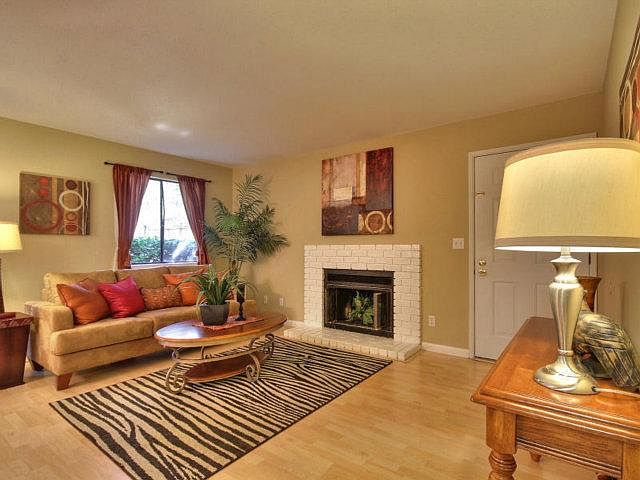 Living room with fireplace (curtains and furniture not included, regular blinds on windows now.