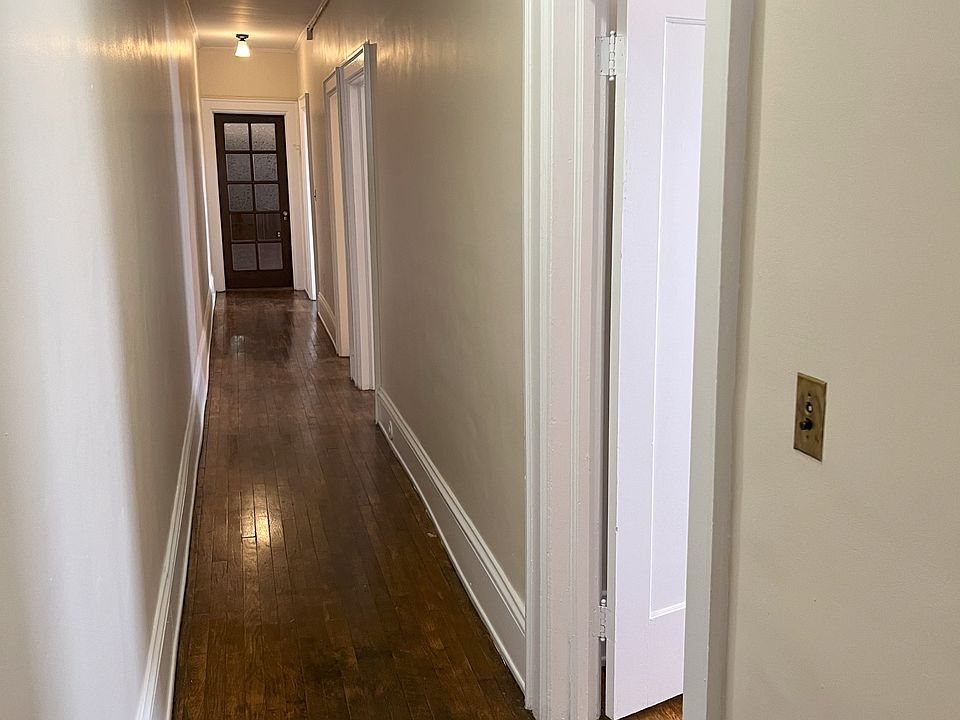 Hallway from the back door leading to the bedrooms, bathroom, kitchen and dining room.