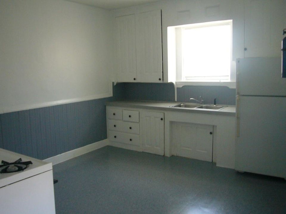Large eat in kitchen with refrigerator and gas stove