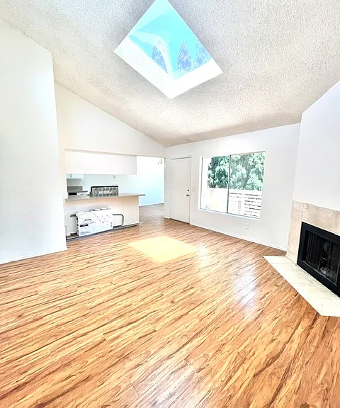 Living room into kitchen/dining area with previous floors in similar unit