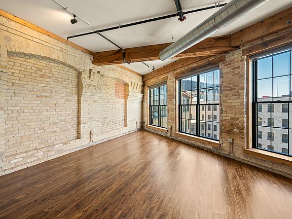 Exposed Cream City brick, exposed heavy timber construction and vertical joist ceilings