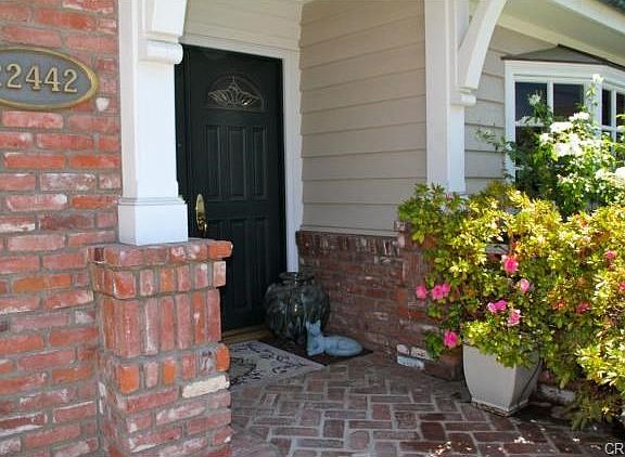Herringbone brick porch welcomes you to a double door entry.