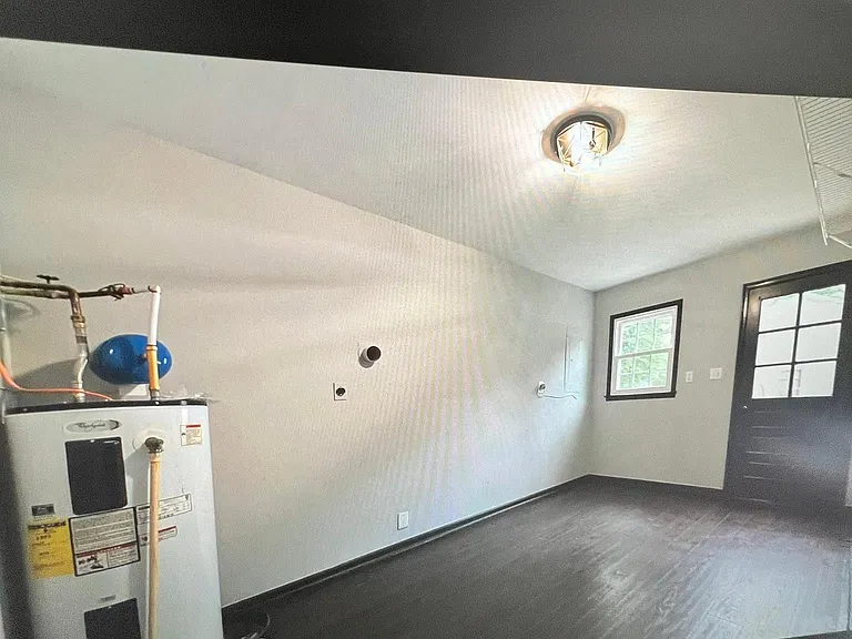 Lower floor laundry room and good place for bikes and storage. Washer dryer on the left of the water heater not visible. Spacious room!