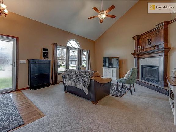 Vaulted Ceiling, Corner Fireplace, Ceiling Fan, Triple Windows, Wood floor entrance and updated paint.